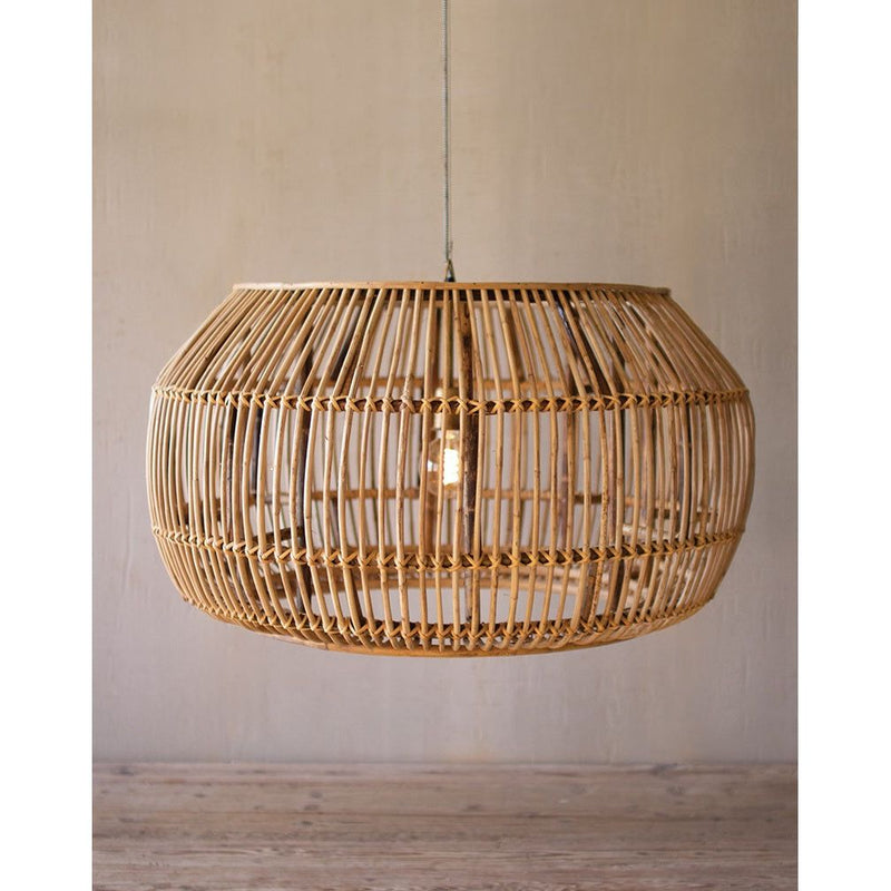 In a coastal space, the Kalalou Large Split Bamboo Pendant hangs gracefully against a neutral wall, adding a touch of tropical flair.