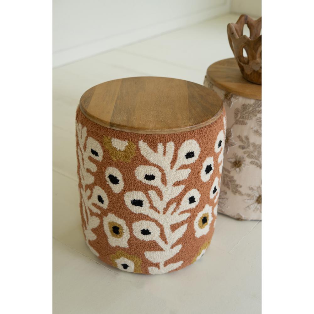 Wooden stool with floral pattern on a white surface
