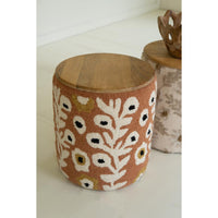 Wooden stool with floral pattern on a white surface