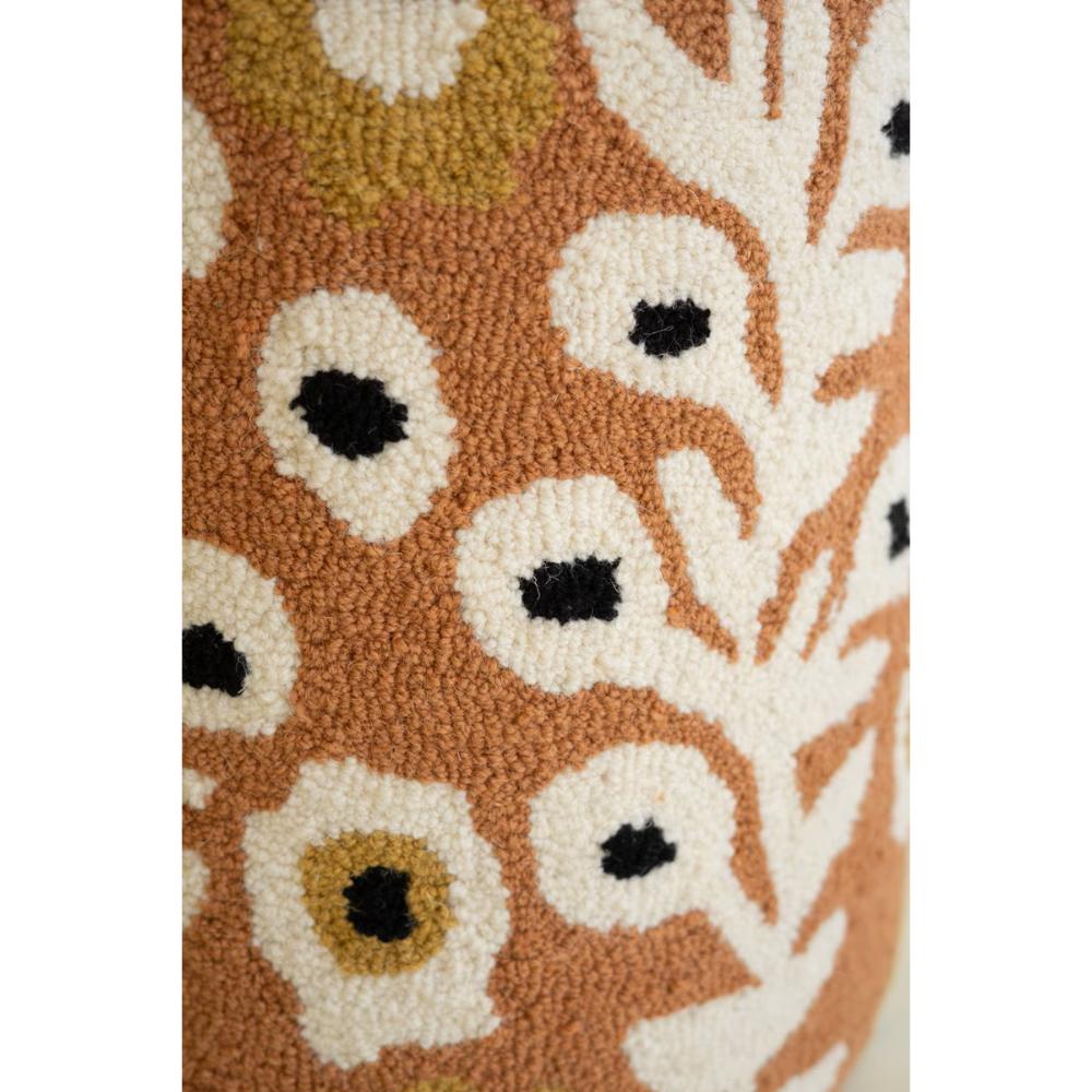 Close-up of a floral patterned rug with white flowers on a brown background