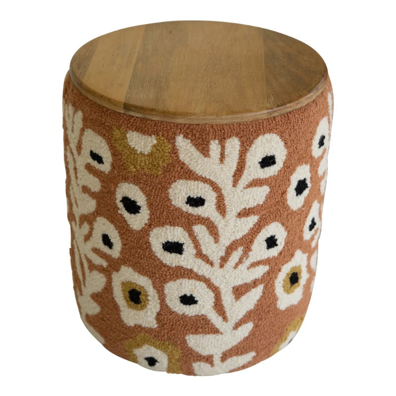 Wooden stool with a floral patterned cushion on a white background