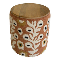 Wooden stool with a floral patterned cushion on a white background