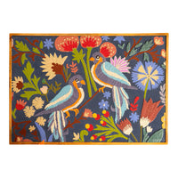 Decorative rug with birds and floral patterns on a blue background