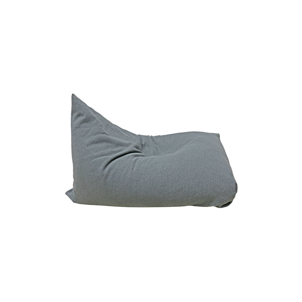A soft, gray Lorena Canals 'Big Puff Emily' floor cushion with a relaxed shape, seen from the side.