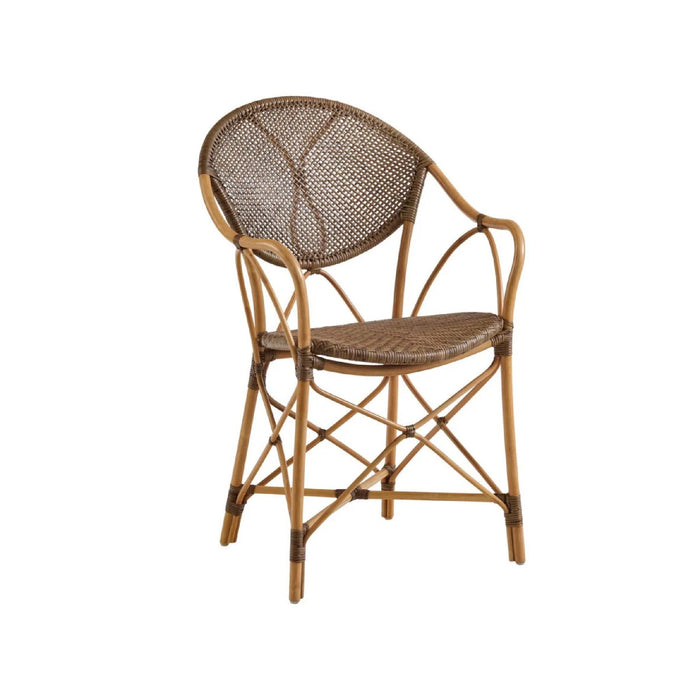 The Kenian Pierre Rattan Chair features a curved backrest, woven seat, and bamboo-style natural rattan frame.