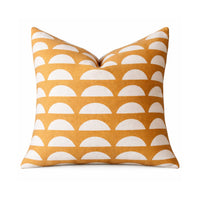 A 20" square throw pillow with a mustard yellow and white half-circle pattern on a white background