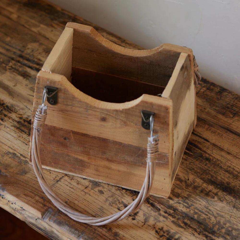 Wooden box with a handle on a wooden surface