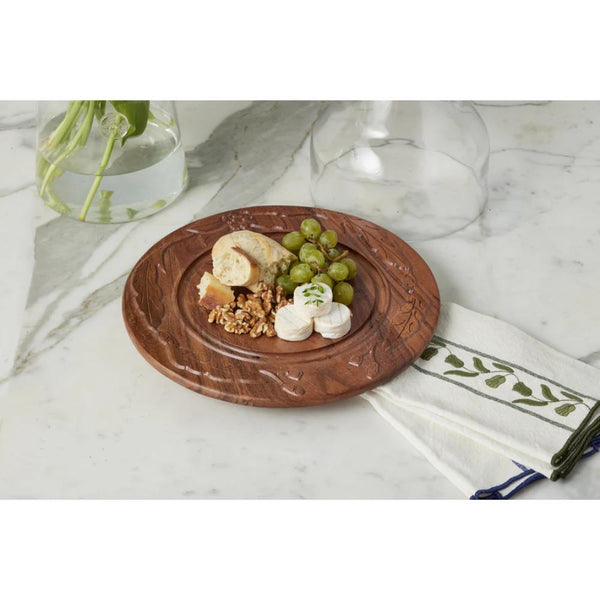 Wooden round board with food on a marble surface