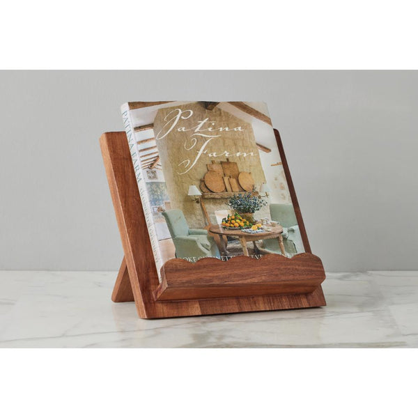 Wooden book stand with a magazine on a white surface