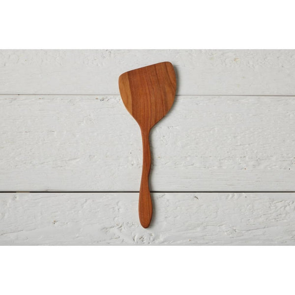Wooden spatula on a light wooden surface