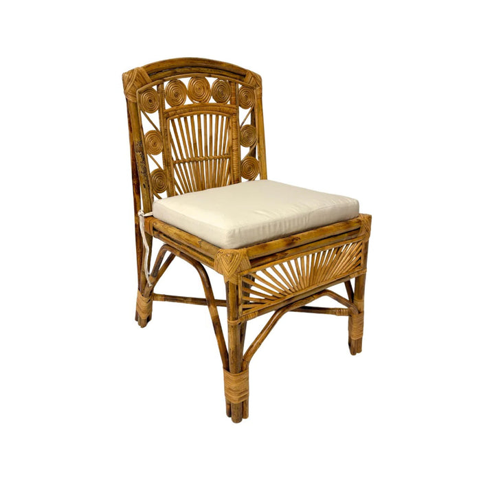 The Robinson Rattan Chair by Varnish Collection features circular patterns and a white cushion on a white background.