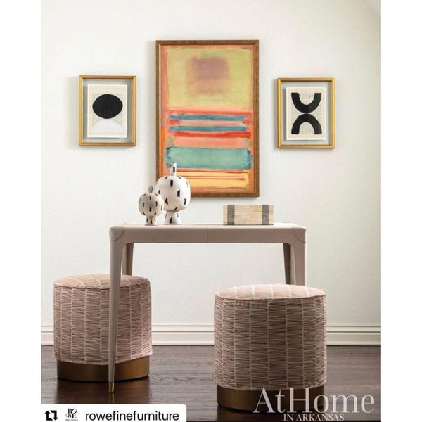 A contemporary entryway featuring the Definition VII Black Modern Framed Art by Shadow Catchers Art, accented with a sleek console table and two woven stools. The decor is completed with geometric sculptures that effortlessly add a modern touch.