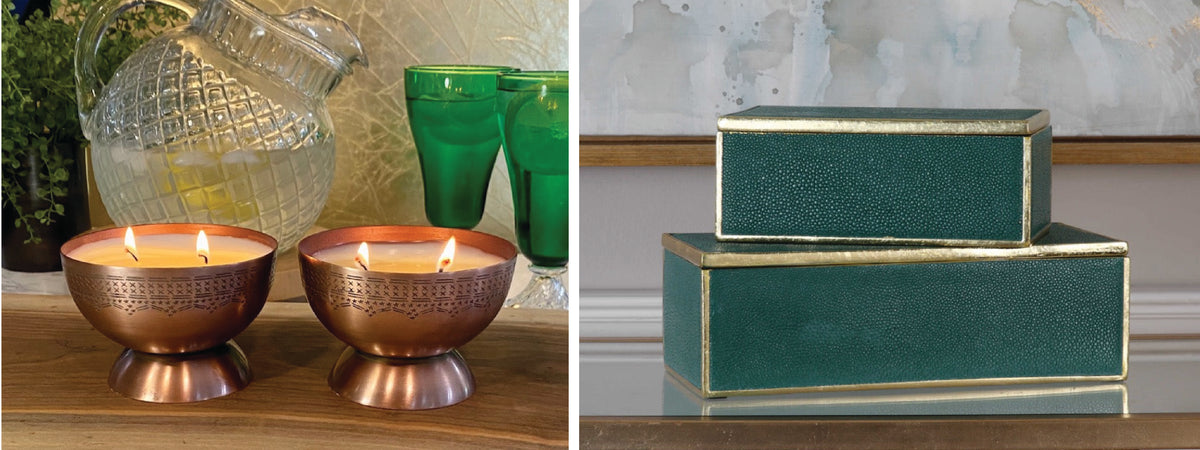 Two lit metallic candles on the left and two green decorative boxes on the right.
