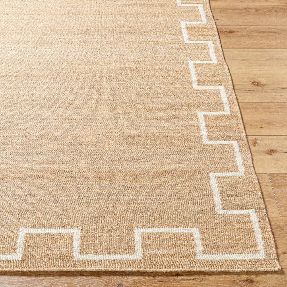 Beige rug with white geometric pattern on a wooden floor