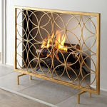 The Circles Contemporary Fireplace Screen by Dessau Home features an iron screen with overlapping circles and an antiqued gold finish.