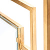Close-up of the Dessau Home Center Panel Glass Antique Gold Fireplace Screen's corner joint, with sharp lines for a modern twist.