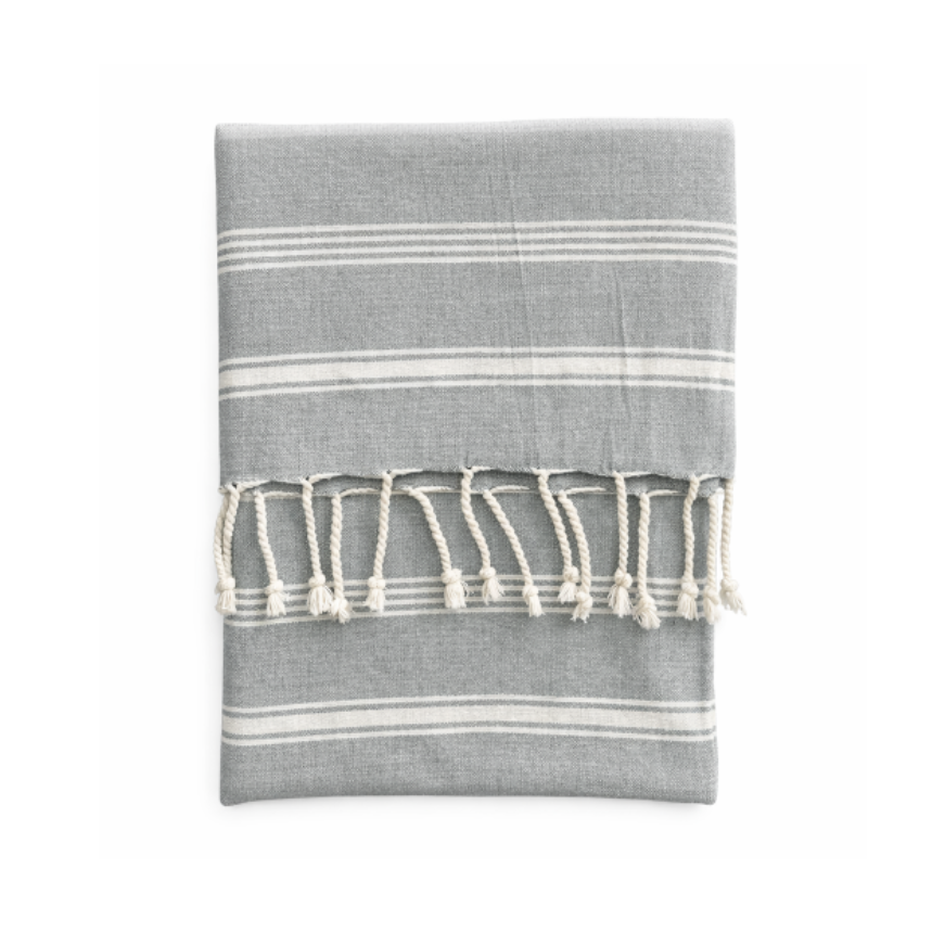 Creative Co-Op Gray + White Woven Cotton Throw with fringed edges, lightweight and neatly folded on a white background.