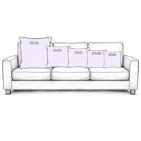 Illustration of a white sofa with decorative pillows of different sizes.