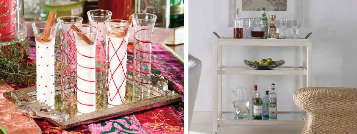 Festive drinks with cinnamon sticks on a tray and a bar cart with various bottles and glasses.