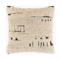 A square shaggy throw pillow in cream beige with dark brown abstract woven patterns, shown against a plain white background.
