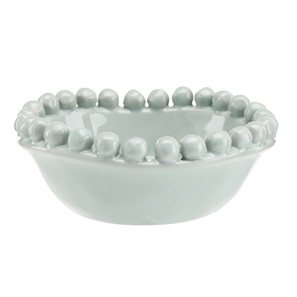 Light blue ceramic bowl with bead-like embellishments on a white background