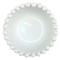 White ceramic bowl with bead-like edge on a white background