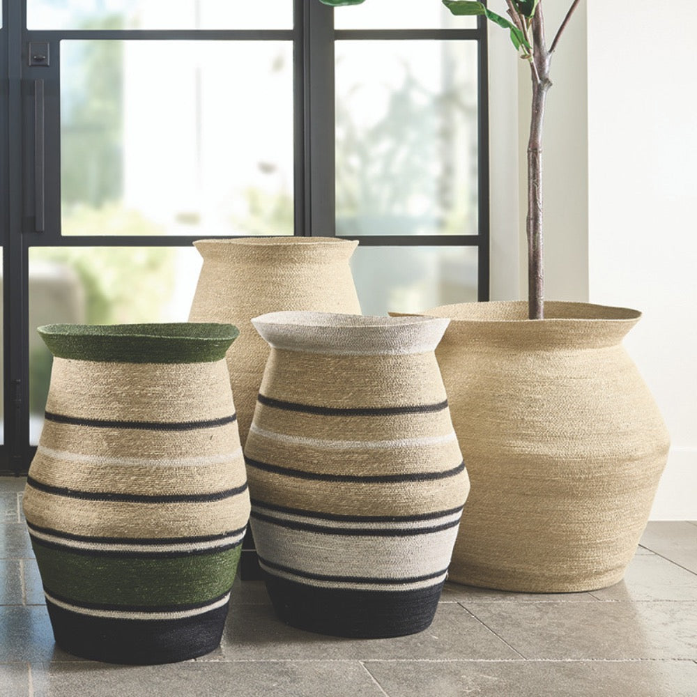 Set of decorative baskets with striped patterns on a tiled floor.