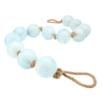 Light blue beaded garland with brown rope on a white background