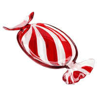 A glossy glass candy-shaped decorative object with alternating red and white vertical stripes, shown on a plain white background.