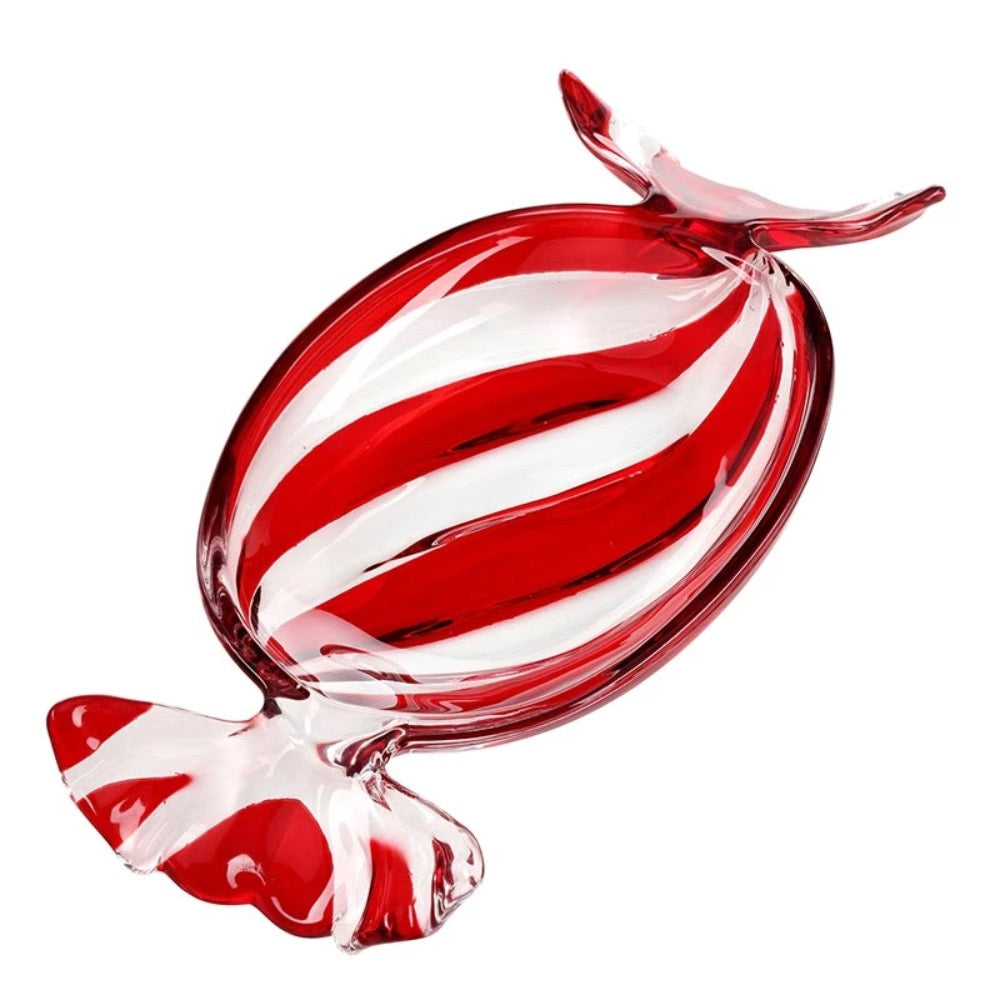 A red and white striped glass candy sculpture on a solid white background.