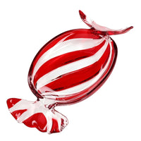 A red and white striped glass candy sculpture on a solid white background.