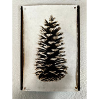 Barloga Studios presents the Loblolly Pinecone Photography Art, skillfully framed on the wall. This black and white print is beautifully showcased on Nepalese handmade paper, providing a unique texture and elegance. The archival wood frames enhance its preservation and timeless charm.