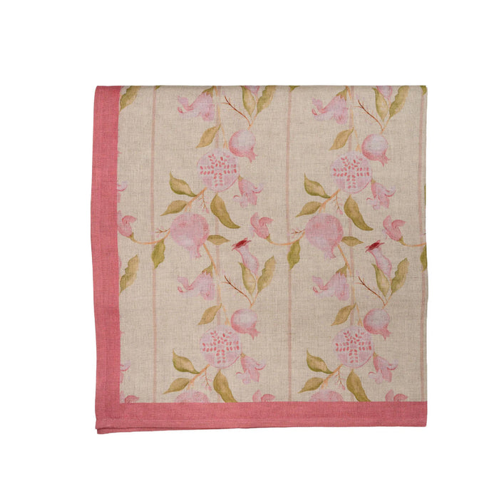 Floral patterned tablecloth with pink flowers and green leaves on a white background