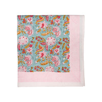 Floral patterned tablecloth with pink border on a white background