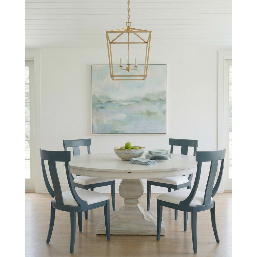 white dining table blue modern chairs, chandelier and abstract painting in background