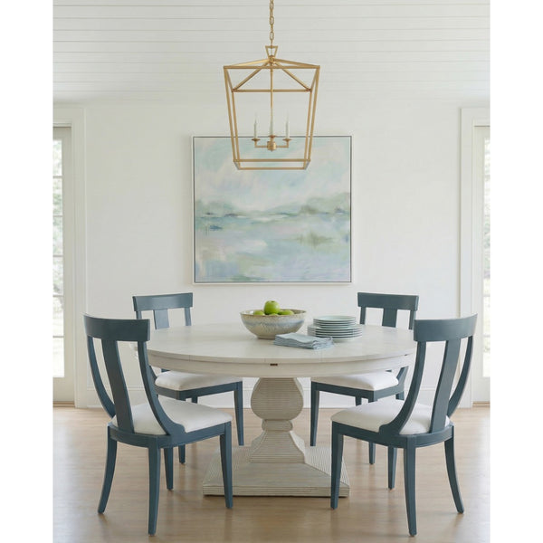 white dining table blue modern chairs, chandelier and abstract painting in background