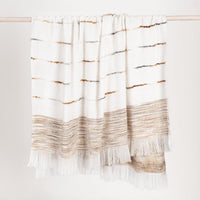 Textured blanket with gold and brown stripes on a white background