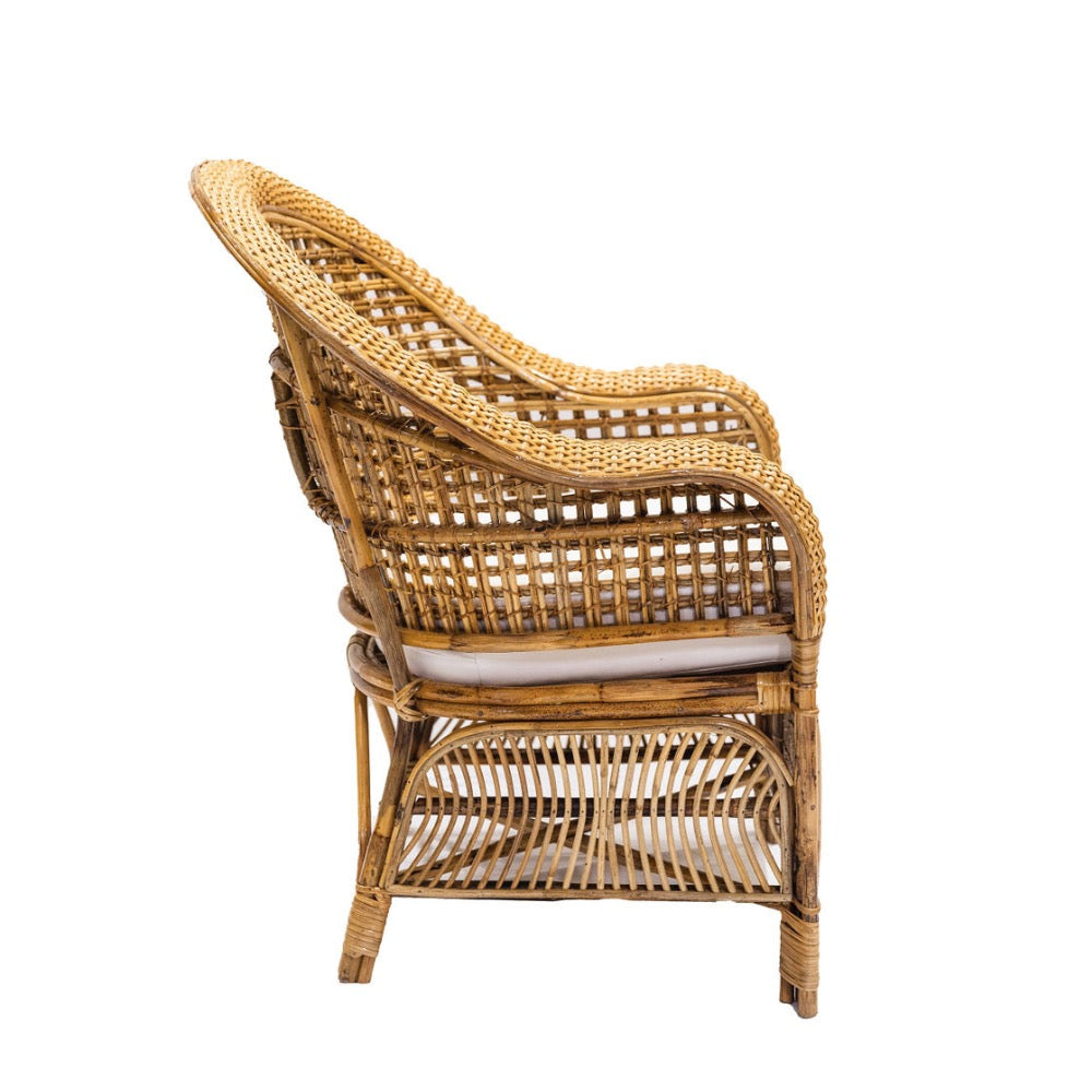 Wicker armchair with a white cushion on a white background
