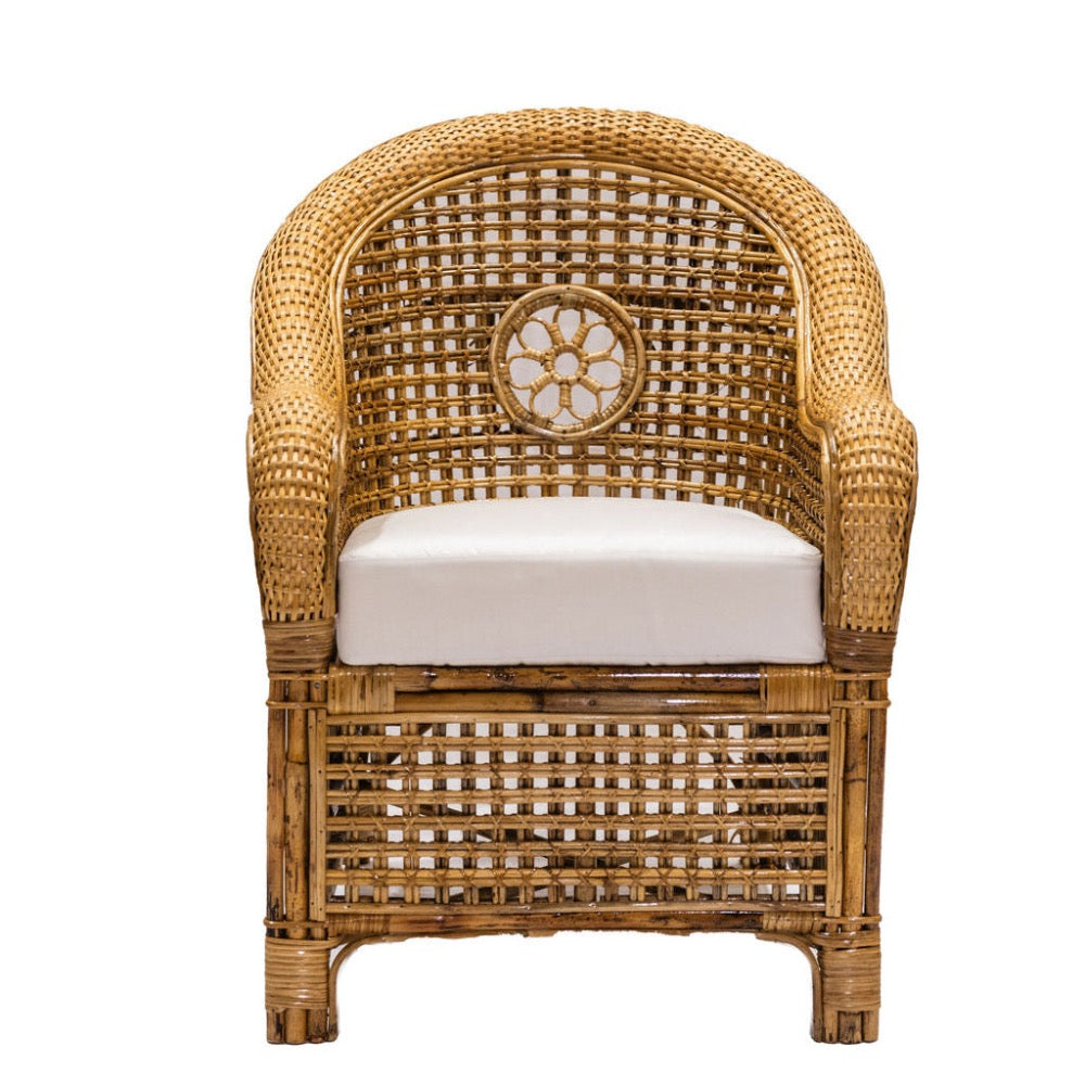 Wicker chair with a white cushion on a white background