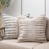 Textured throw pillows on a sofa with a neutral background