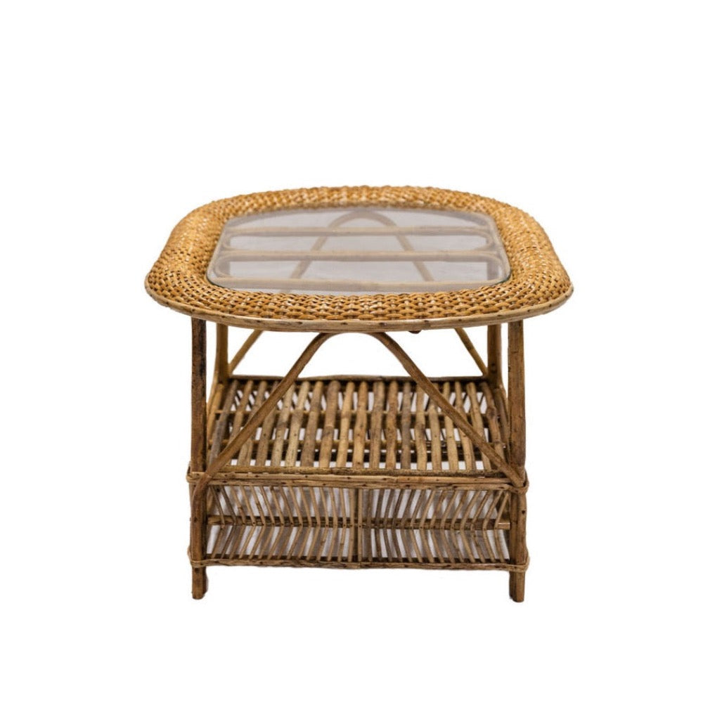 Wicker side table with glass top on a white background
