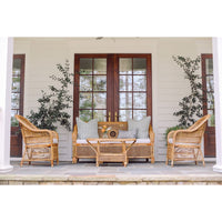 Wicker outdoor furniture set on a porch with decorative elements.