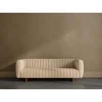 Beige sofa against a plain wall