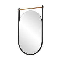 An oval wall mirror with a sleek black metal frame and a natural wood hanging rod, shown against a plain white background.