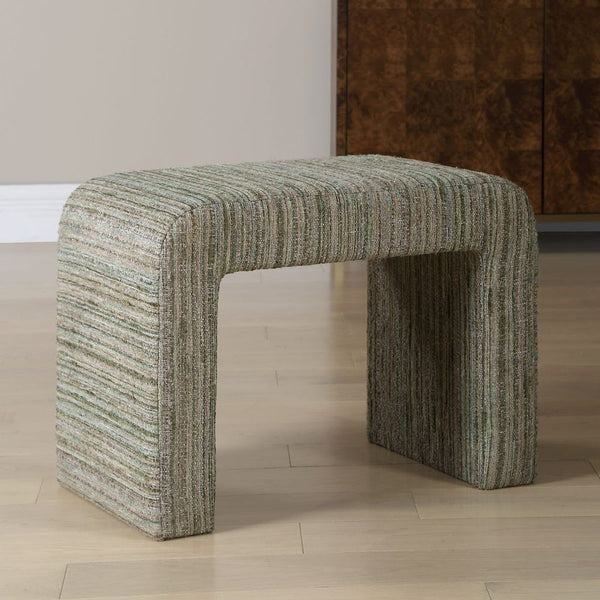Textured green stool on a wooden floor with a neutral wall background