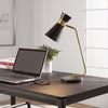The Uttermost Black + Gold Desk Lamp with a black marble base sits on a modern dark wood desk beside a laptop.