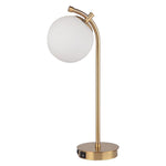 The Uttermost Glass Globe Desk Lamp features a white globe shade and USB port in its sleek brass base.