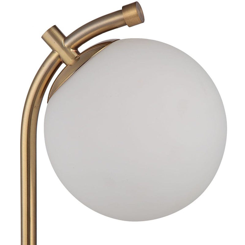 Uttermost Glass Globe Desk Lamp features an antique gold finish, curved arm, and round white glass globe shade.