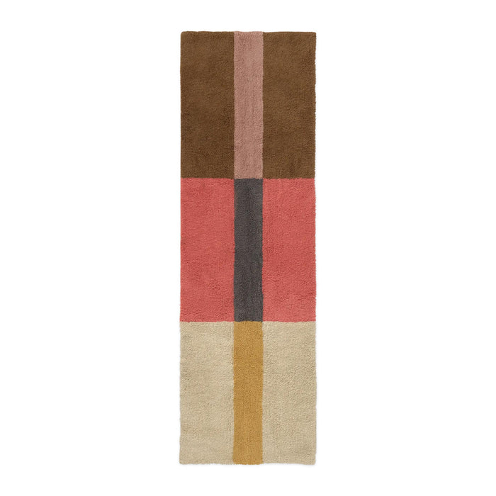A rectangular area rug with a mid-century modern color-blocked pattern, featuring sections of brown, dusty pink, coral red, charcoal gray, cream, and mustard yellow on a white background.