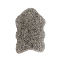 A gray shaggy sheepskin-style rug or throw with an irregular natural hide shape, shown against a plain white background.